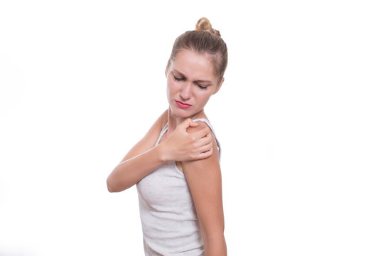 Acute pain in a woman shoulder. Female holding shoulder