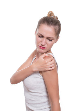Acute pain in a woman shoulder. Female holding shoulder