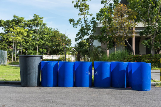 A lot of blue garbage bins at public parks