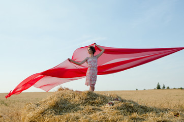 girl in field with cloth