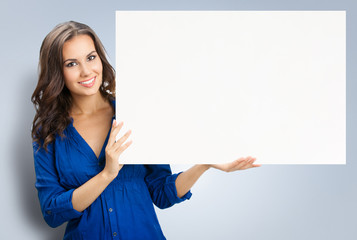 Beautiful young woman showing blank signboard
