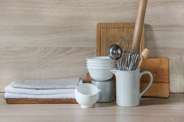 Crockery, tableware, utensils and other different stuff on wooden table-top. Kitchen still life as background for design.  Image with copy space. 