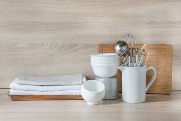 Crockery, tableware, utensils and other different stuff on wooden table-top. Kitchen still life as background for design.  Image with copy space. 