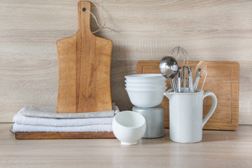 Crockery, tableware, utensils and other different stuff on wooden table-top. Kitchen still life as background for design.  Image with copy space. 