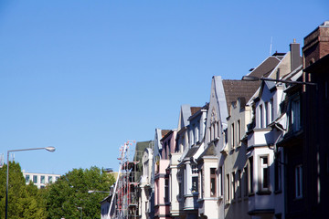 Historic Renaissance Revival architecture in the Frankenberger Quarter, Aachen, Germany with townhouses with ornate stone carving and dormer windows against a blue sky