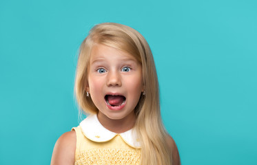 Funny, pretty young girl on blue background