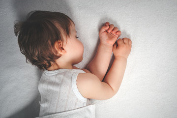 Baby sweet sleeping on a white bed background