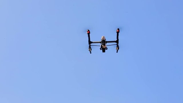 Copter drone fly against blue sky close up