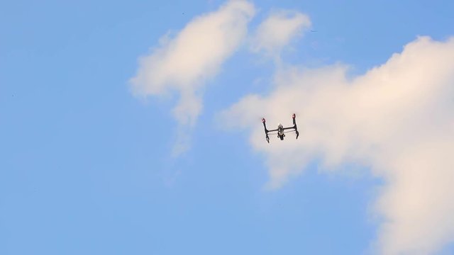 Copter drone fly against blue sky close up