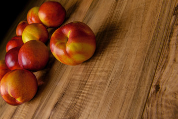 Fresh ripe peaches on the wooden table