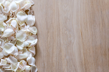 Creative arrangement made of different flowers on wooden background with space for text.