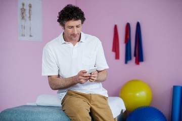 Physiotherapist using mobile phone