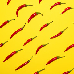 Red hot chili peppers on yellow background - Flat lay