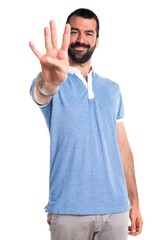 Man with blue shirt counting four