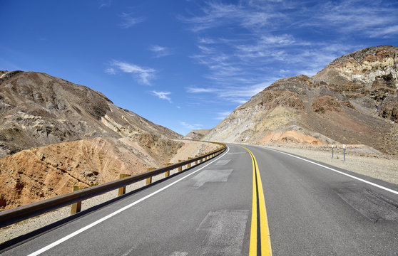 Empty highway in mountainous terrain, travel concept.