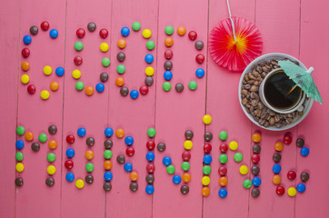 inscription from candies on a pink background