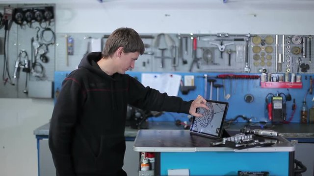 Yacht specialist looks at the scheme on the tablet