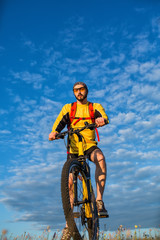 Fototapeta premium Young man cycling on a rural road