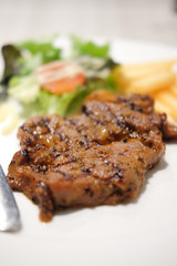 Juicy grilled pork chop  with french fries