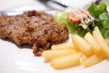 grilled steak, french fries and vegetables