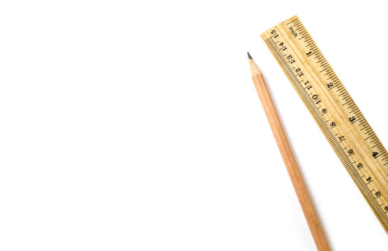 Wooden pencil an ruler on white isolated background