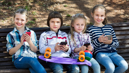 Portrait of girls and boys playing with phones
