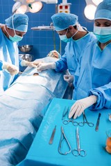 Surgeons performing operation in operation room