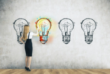 Girl coloring light bulb