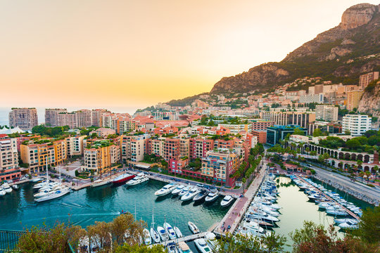 Panoramic view of Port de Fontvieille in Monaco. Azur coast. Colorful bay with a lot of luxury yachts in sunset.
