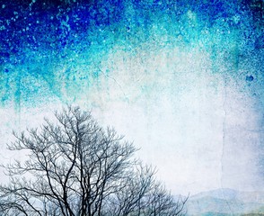 Grunge bare tree on textured blue background
