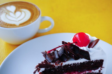 piece of chocolate cake and latte art coffee
