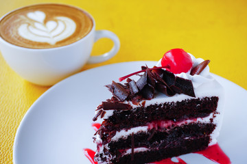 piece of chocolate cake and latte art coffee