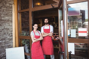 Portrait of couple standing with arms crossed