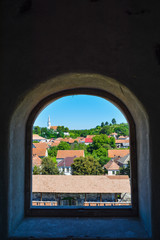 Beautiful view over Racos village from the citadel tower through the window, in Romania