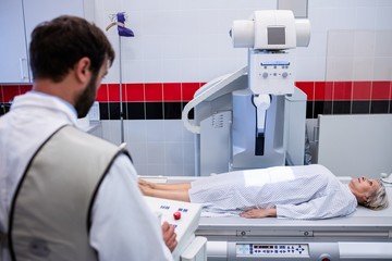 Doctor using x-ray machine to examine patient