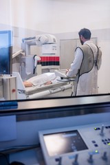 Doctor using x-ray machine to examine patient