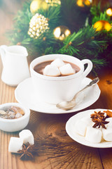 Mug filled Hot chocolate and Marshmallows on old wooden background. Christmas time, selective focus. Holiday concept, toned