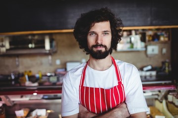 Portrait of male baker standing with arms crossed
