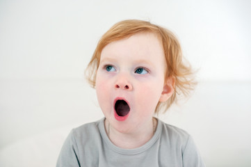 The red-haired child yawns