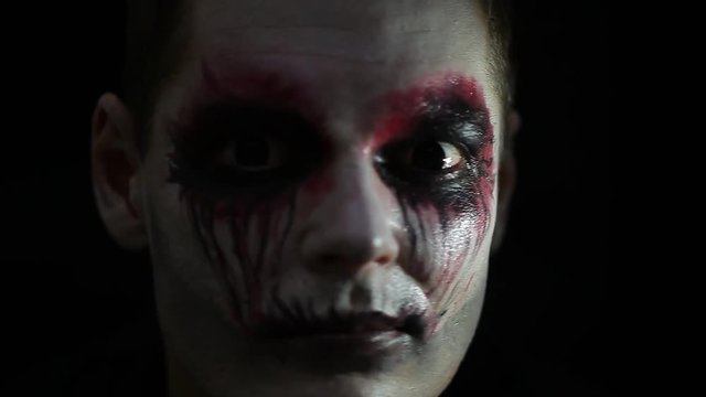Portrait man with Halloween skull makeup. Halloween or horror theme.