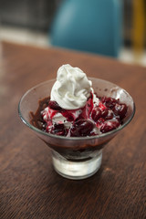 ice cream topped with hot cherries .