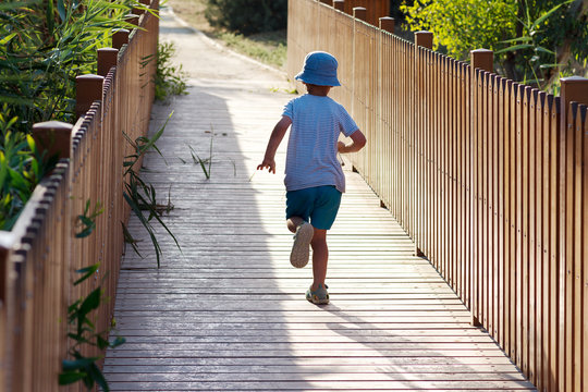 Child Running On Nature Path