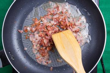 frying bacon in the pan