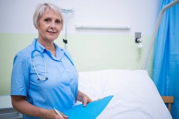 Portrait of nurse holding file 