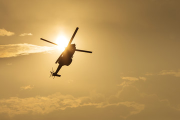 IAR Puma helicopter silhouette flying in the cloudy sky, stunt a © danmir12