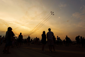 People taking pictures on a airshow at sunset - obrazy, fototapety, plakaty