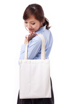 Happy, Smiling Asian Woman Carrying Reusable Cotton Bag