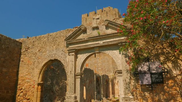 A cinematic shot featuring a medieval church in ruins inside the Palmela Castle (Castelo de Palmela) in Portugal dating from 12th century.
