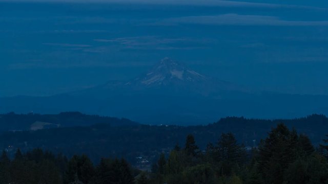 Ultra high definition 4k time lapse movie of full moon rising over Mount Hood in Happy Valley Oregon from dusk into blue hour into night during harvest festival in August 4096x2304