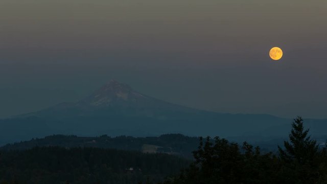 Ultra high definition 4k time lapse movie of full moon rising over Mount Hood and city of Happy Valley Oregon from sunset into blue hour during harvest festival in August 4096x2304